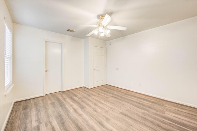 19138 S Whimsey Dr, Cypress, TX 77433 - unfurnished bedroom featuring light wood-type flooring, multiple windows, and ceiling fan
