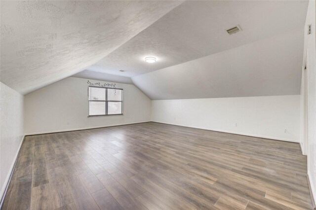 19138 S Whimsey Dr, Cypress, TX 77433 - bonus room featuring lofted ceiling, wood finished floors, and a textured ceiling