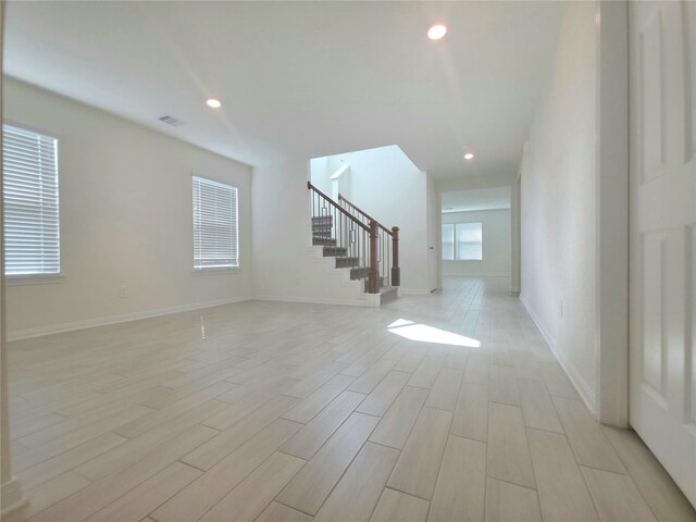 4122 Mossy Bank Ln, Houston, TX 77068 - unfurnished living room with stairway, light wood-style flooring, and recessed lighting