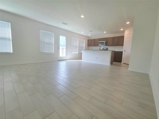 4122 Mossy Bank Ln, Houston, TX 77068 - unfurnished living room with recessed lighting and baseboards