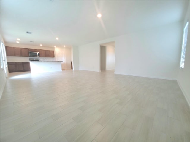 4122 Mossy Bank Ln, Houston, TX 77068 - unfurnished living room with recessed lighting and light wood finished floors