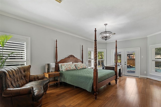 7814 Magnolia Cove Ct, Houston, TX 77346 - bedroom featuring a chandelier, access to outside, wood finished floors, and ornamental molding