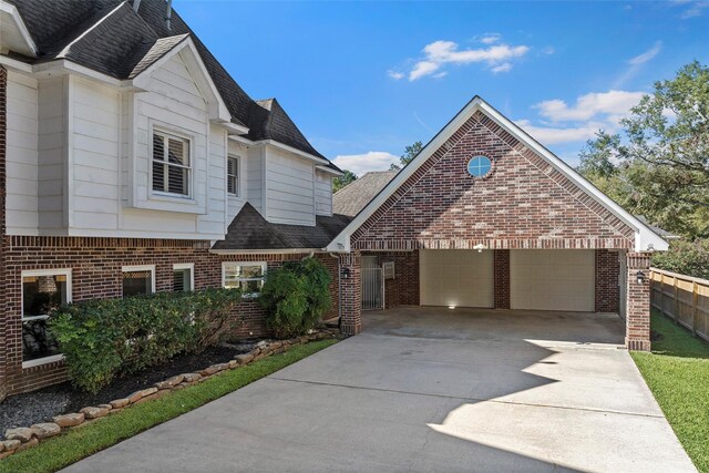 7814 Magnolia Cove Ct, Houston, TX 77346 - view of front of property featuring brick siding, a shingled roof, and a garage