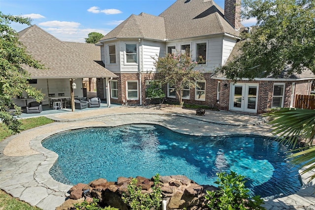 7814 Magnolia Cove Ct, Houston, TX 77346 - outdoor pool with french doors, an outdoor hangout area, and a patio area