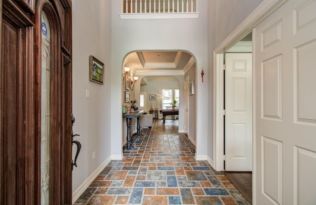 16506 Dawson Mill Ct, Houston, TX 77095 - foyer featuring arched walkways, crown molding, and stone tile floors