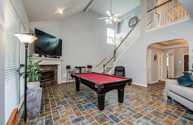 16506 Dawson Mill Ct, Houston, TX 77095 - playroom with stone tile flooring, beam ceiling, ceiling fan, arched walkways, and high vaulted ceiling