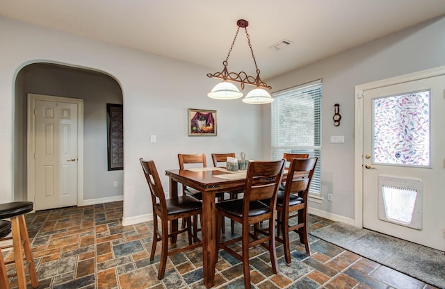 16506 Dawson Mill Ct, Houston, TX 77095 - dining room featuring stone tile floors and arched walkways