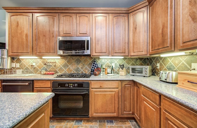 16506 Dawson Mill Ct, Houston, TX 77095 - kitchen featuring appliances with stainless steel finishes, backsplash, dark stone finish flooring, and light stone counters