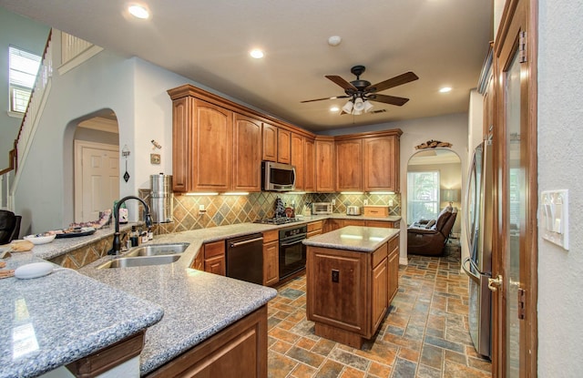 16506 Dawson Mill Ct, Houston, TX 77095 - kitchen featuring arched walkways, stainless steel appliances, decorative backsplash, a ceiling fan, and plenty of natural light