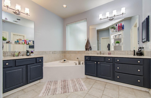 16506 Dawson Mill Ct, Houston, TX 77095 - bathroom with tile patterned floors, two vanities, and a bath