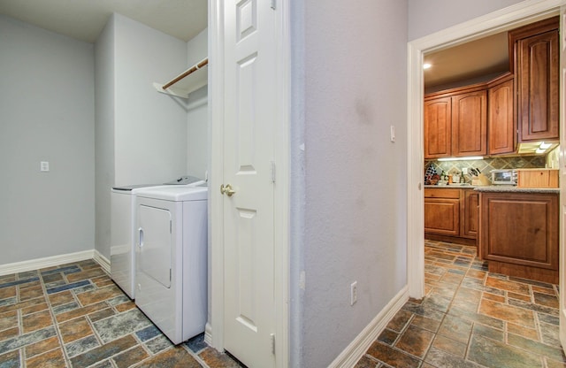 16506 Dawson Mill Ct, Houston, TX 77095 - washroom featuring stone tile floors and washing machine and dryer