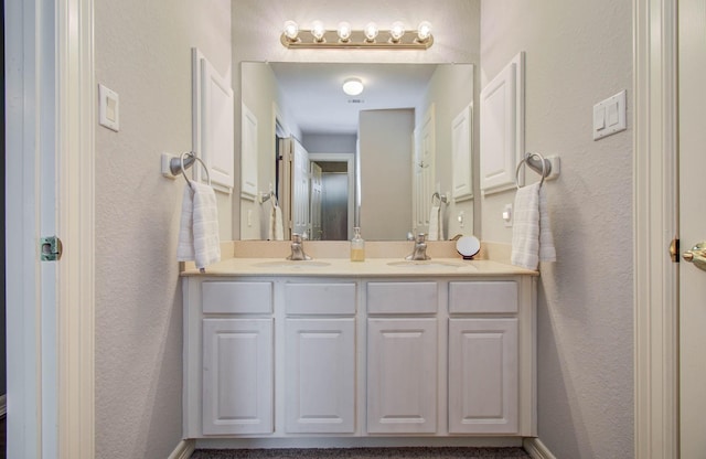 16506 Dawson Mill Ct, Houston, TX 77095 - bathroom featuring double vanity and a textured wall