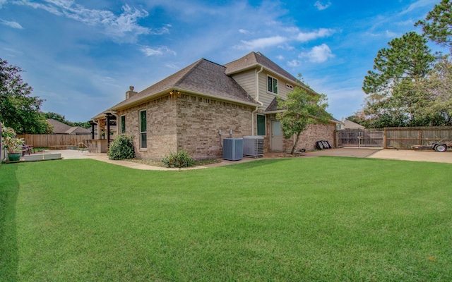 16506 Dawson Mill Ct, Houston, TX 77095 - rear view of house with a patio, a fenced backyard, brick siding, and a chimney