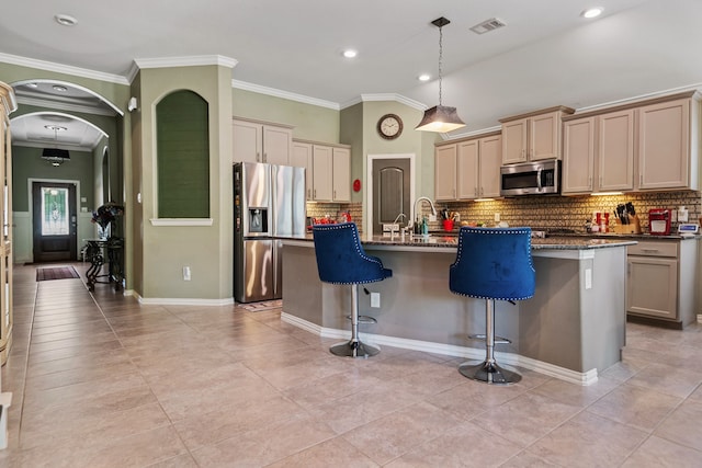23613 Alder Branch Ln, New Caney, TX 77357 - kitchen featuring appliances with stainless steel finishes, backsplash, a kitchen bar, a center island with sink, and ornamental molding