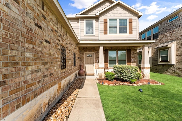 6923 Glenmoor Dr, Rosharon, TX 77583 - property entrance with a yard, covered porch, and brick siding