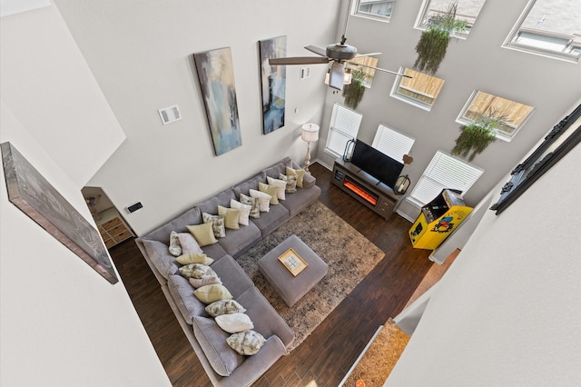 6923 Glenmoor Dr, Rosharon, TX 77583 - living area featuring a towering ceiling, healthy amount of natural light, wood finished floors, and ceiling fan