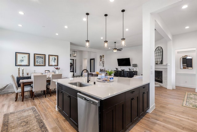 1703 Rosings Way, Katy, TX 77493 - kitchen featuring dishwasher, open floor plan, a ceiling fan, a fireplace, and light wood finished floors