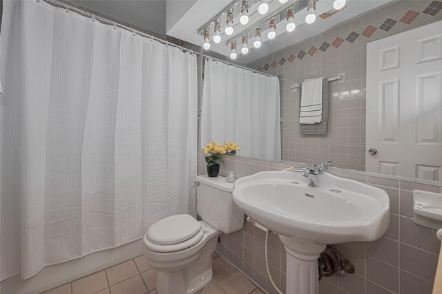 7230 Redding Rd, Houston, TX 77036 - full bathroom with tile patterned floors, tile walls, and shower / bathtub combination with curtain