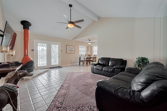 7230 Redding Rd, Houston, TX 77036 - living room featuring a wood stove, ceiling fan, beam ceiling, light tile patterned flooring, and high vaulted ceiling