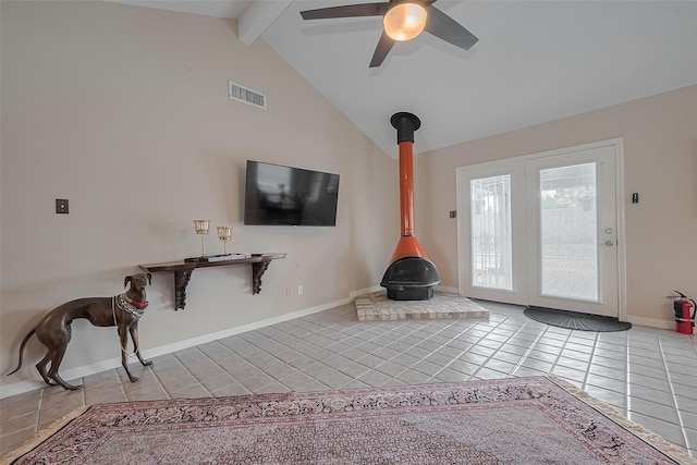 7230 Redding Rd, Houston, TX 77036 - unfurnished living room featuring tile patterned floors, a wood stove, beamed ceiling, a ceiling fan, and high vaulted ceiling