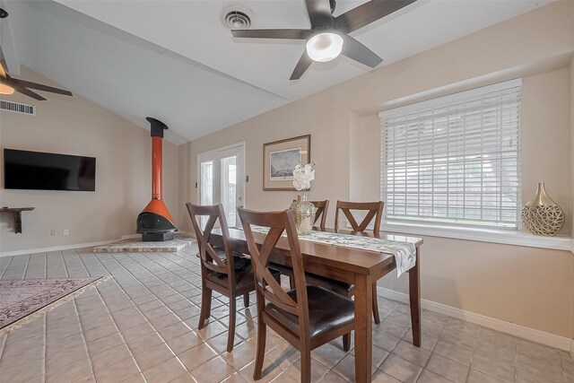 7230 Redding Rd, Houston, TX 77036 - dining room with a ceiling fan, a wood stove, lofted ceiling, and light tile patterned floors