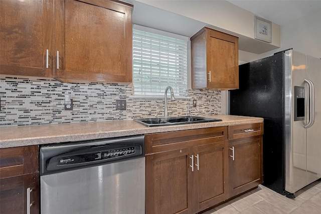 7230 Redding Rd, Houston, TX 77036 - kitchen featuring appliances with stainless steel finishes, light countertops, decorative backsplash, and light tile patterned flooring