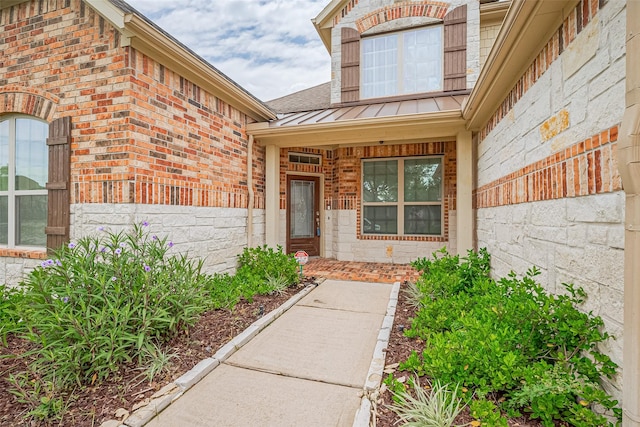 310 Blossom Terrace Ln, Rosenberg, TX 77469 - view of exterior entry with a standing seam roof, brick siding, and a metal roof