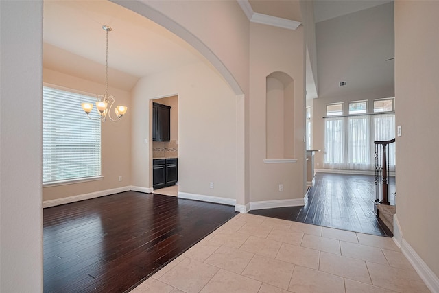 310 Blossom Terrace Ln, Rosenberg, TX 77469 - entryway with hardwood / wood-style flooring, a chandelier, arched walkways, and vaulted ceiling