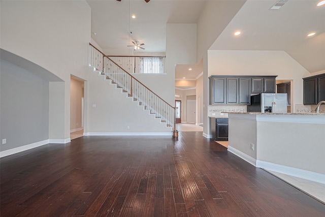 310 Blossom Terrace Ln, Rosenberg, TX 77469 - kitchen with stainless steel fridge with ice dispenser, a high ceiling, dark wood-type flooring, a ceiling fan, and backsplash
