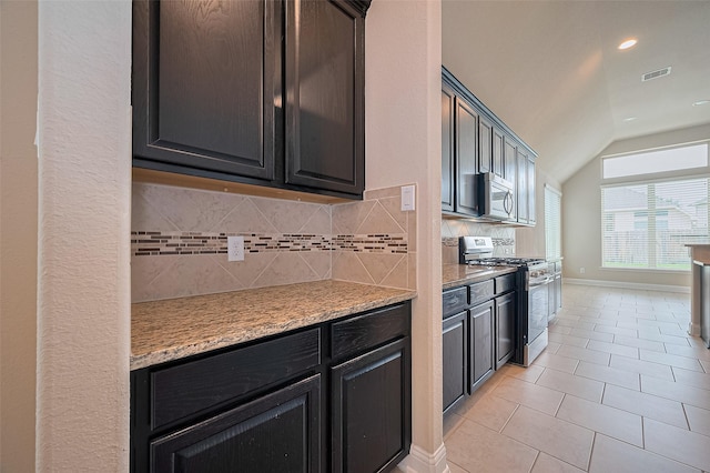 310 Blossom Terrace Ln, Rosenberg, TX 77469 - kitchen with appliances with stainless steel finishes, vaulted ceiling, decorative backsplash, light tile patterned floors, and recessed lighting