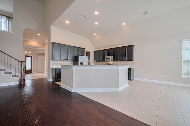 310 Blossom Terrace Ln, Rosenberg, TX 77469 - kitchen featuring stainless steel appliances, decorative backsplash, plenty of natural light, high vaulted ceiling, and a kitchen island with sink