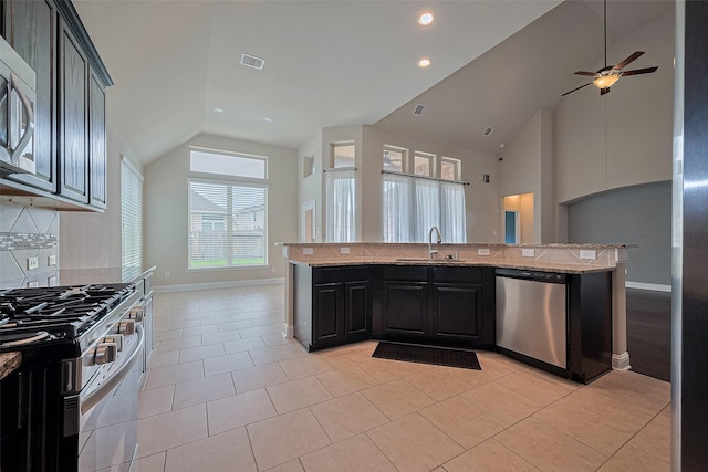 310 Blossom Terrace Ln, Rosenberg, TX 77469 - kitchen featuring appliances with stainless steel finishes, light stone counters, open floor plan, ceiling fan, and light tile patterned flooring