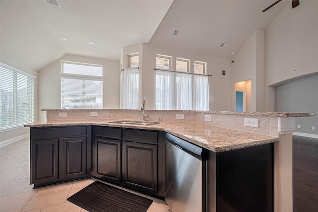 310 Blossom Terrace Ln, Rosenberg, TX 77469 - kitchen with stainless steel dishwasher, lofted ceiling, light stone countertops, decorative backsplash, and a center island with sink