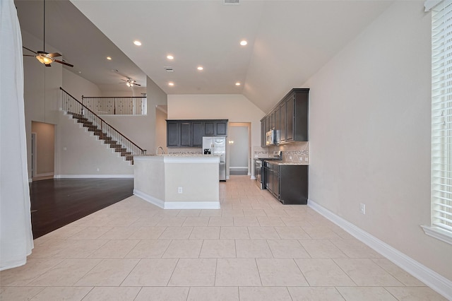 310 Blossom Terrace Ln, Rosenberg, TX 77469 - kitchen featuring open floor plan, appliances with stainless steel finishes, a ceiling fan, light countertops, and high vaulted ceiling