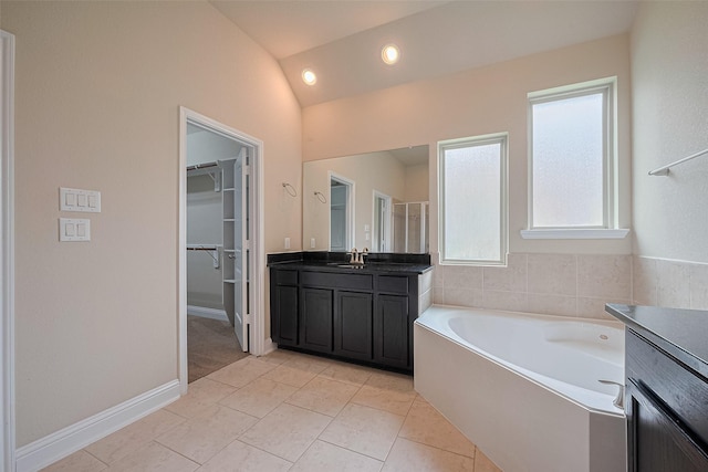 310 Blossom Terrace Ln, Rosenberg, TX 77469 - full bathroom featuring vanity, a garden tub, vaulted ceiling, a walk in closet, and a shower