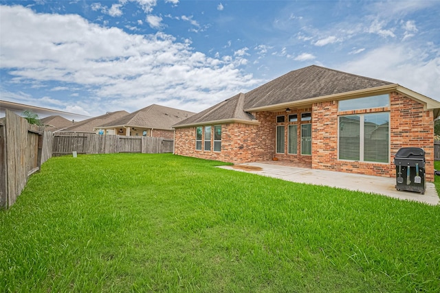 310 Blossom Terrace Ln, Rosenberg, TX 77469 - rear view of house featuring brick siding, a fenced backyard, a patio area, and roof with shingles