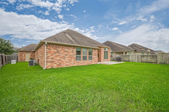 310 Blossom Terrace Ln, Rosenberg, TX 77469 - rear view of property featuring a fenced backyard, brick siding, a patio, and roof with shingles