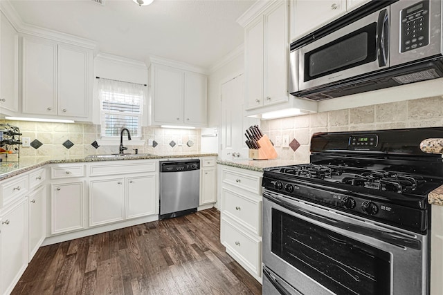 4401 Marina St Unit B, Houston, TX 77007 - kitchen with appliances with stainless steel finishes, white cabinets, and dark wood-style floors