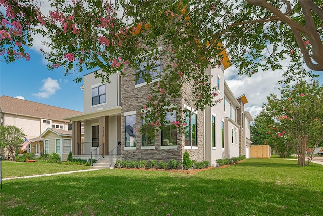 5200 Beech St, Bellaire, TX 77401 - view of front of property with stone siding, a front lawn, and stucco siding