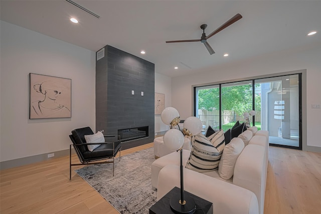 5200 Beech St, Bellaire, TX 77401 - living area with a fireplace, a ceiling fan, light wood-style flooring, and recessed lighting