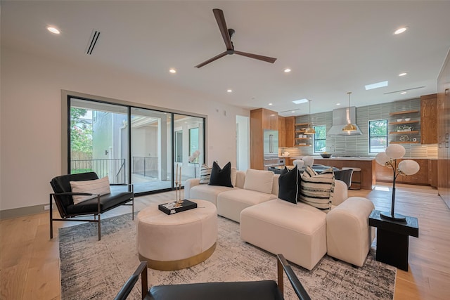 5200 Beech St, Bellaire, TX 77401 - living room with light wood finished floors, recessed lighting, and a ceiling fan
