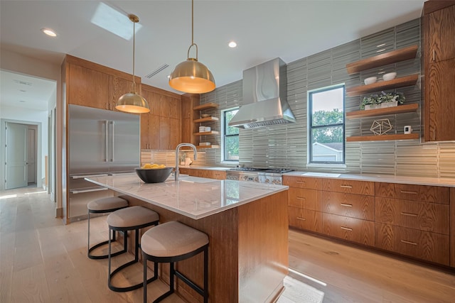 5200 Beech St, Bellaire, TX 77401 - kitchen featuring open shelves, wall chimney range hood, built in refrigerator, brown cabinets, and backsplash