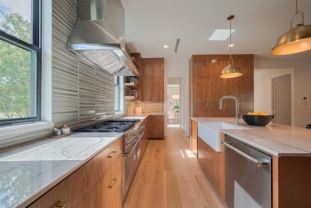 5200 Beech St, Bellaire, TX 77401 - kitchen with stainless steel appliances, extractor fan, brown cabinets, modern cabinets, and light wood-type flooring
