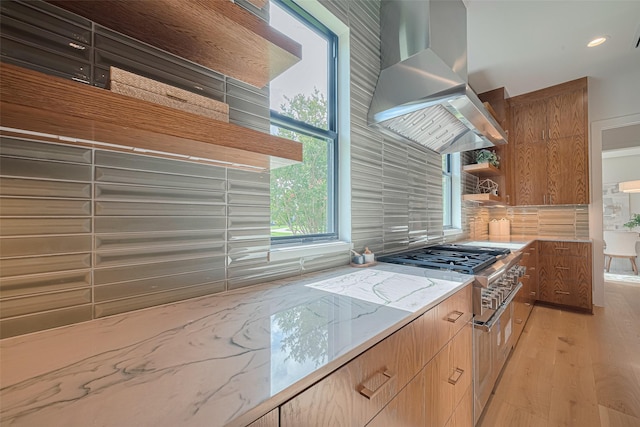 5200 Beech St, Bellaire, TX 77401 - kitchen with wall chimney exhaust hood, high end stainless steel range oven, light stone counters, open shelves, and light wood-type flooring