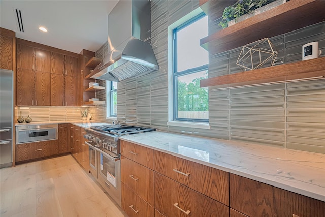 5200 Beech St, Bellaire, TX 77401 - kitchen with open shelves, wall chimney range hood, high end appliances, light wood-type flooring, and light stone counters