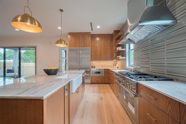 5200 Beech St, Bellaire, TX 77401 - kitchen featuring high end appliances, range hood, open shelves, brown cabinets, and plenty of natural light