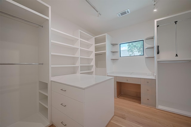 5200 Beech St, Bellaire, TX 77401 - spacious closet featuring light wood-type flooring and built in desk