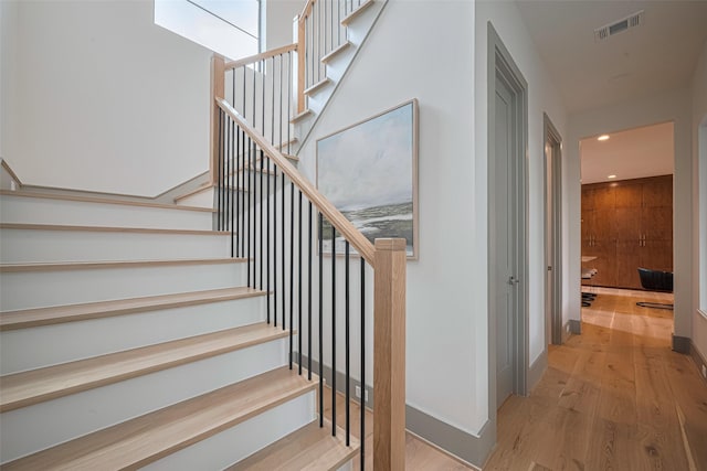 5200 Beech St, Bellaire, TX 77401 - staircase featuring wood finished floors and recessed lighting