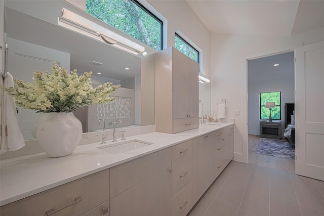 5200 Beech St, Bellaire, TX 77401 - bathroom with healthy amount of natural light, double vanity, tile patterned flooring, and ensuite bath