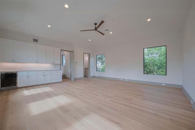 5200 Beech St, Bellaire, TX 77401 - unfurnished living room featuring wine cooler, light wood-type flooring, a ceiling fan, and recessed lighting